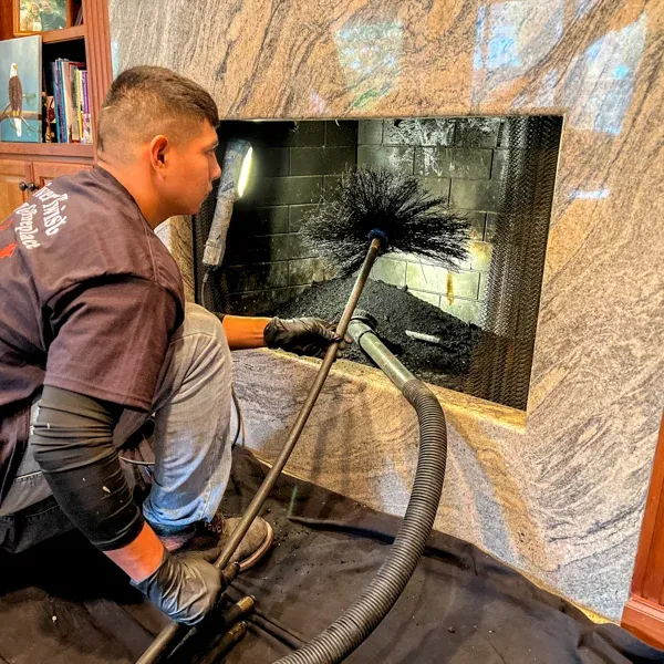 Chimney sweep technician at fireplace — Chimney Goat project