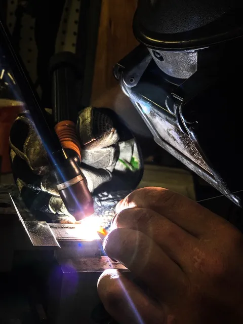 Keenan Vella TIG welding under the arc in the Vella Welding shop