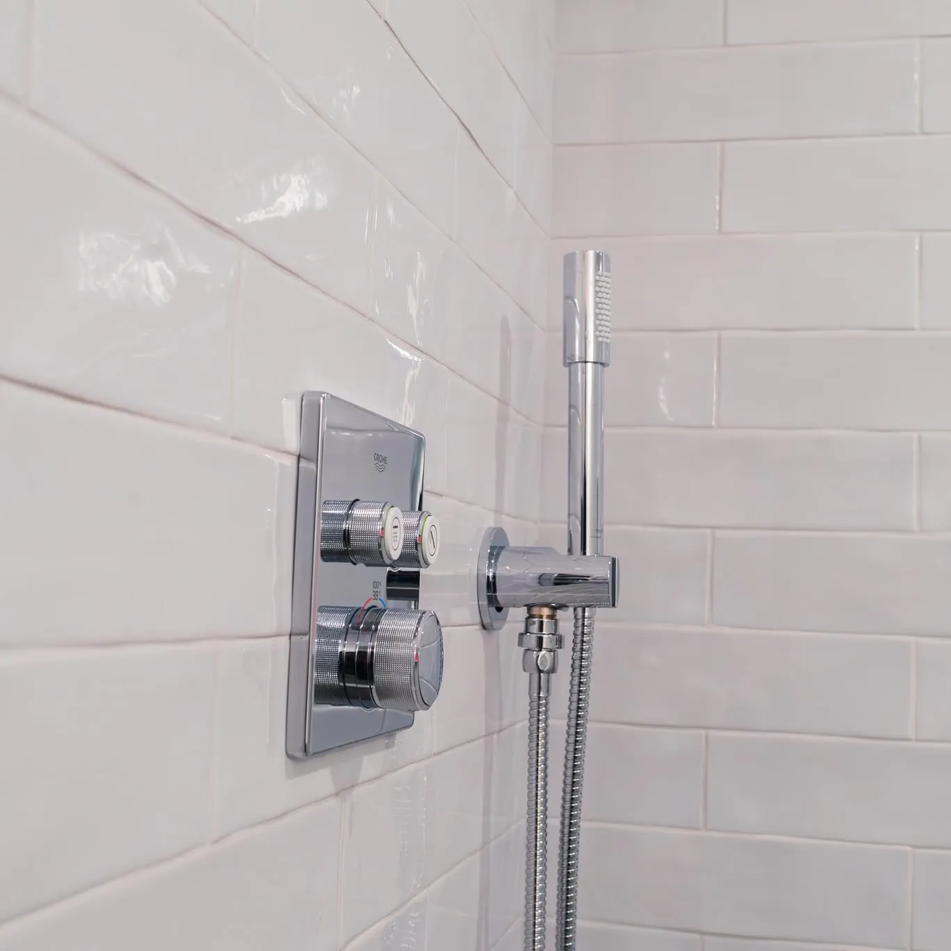 Shower valve and hand shower set in white subway tile