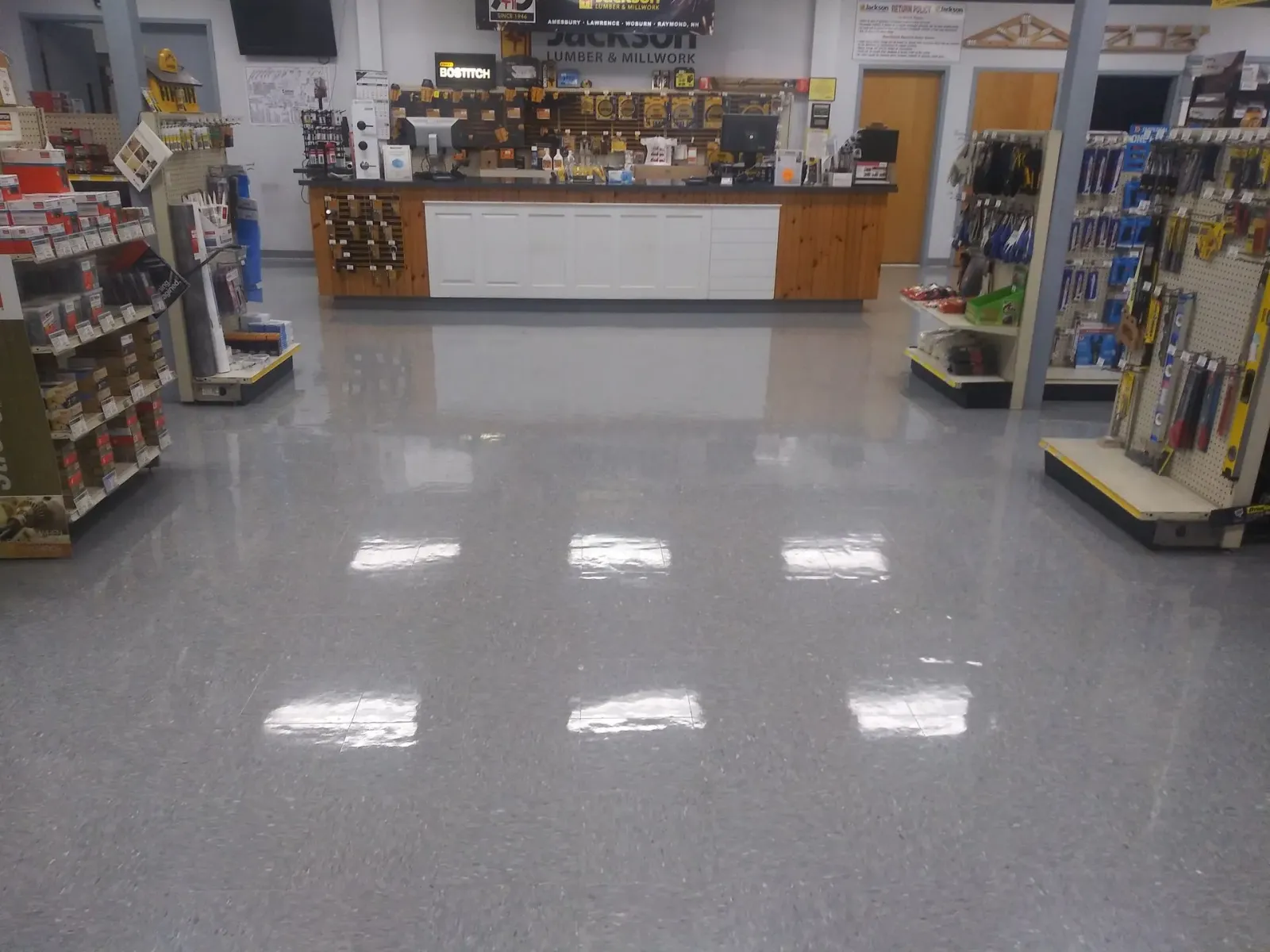 The inside of a hardware store with a counter and shelves
