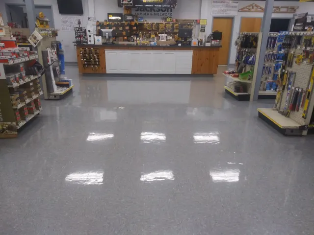 The inside of a hardware store with a counter and shelves