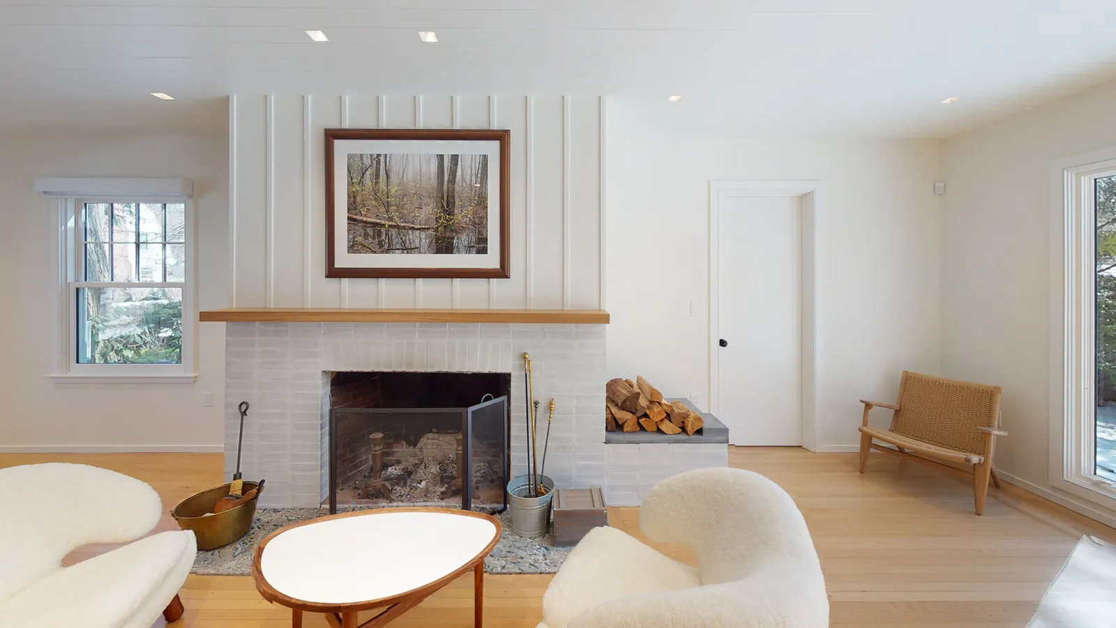 Living room with board-and-batten chimney breast and painted brick firebox
