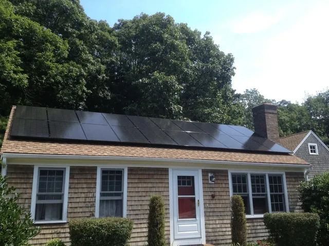 how with wood shingle siding with all black solar panels on roof