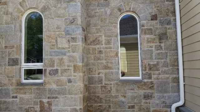 Stone veneer detail around arched windows