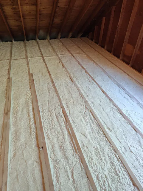There is a lot of insulation on the floor of the attic.