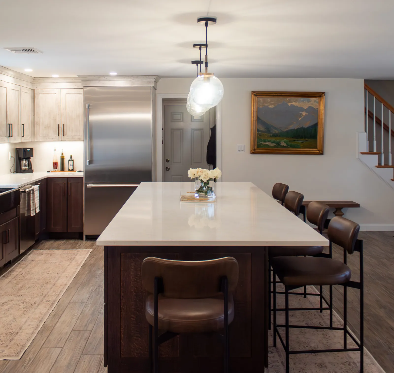 Open kitchen with dark island and counter seating