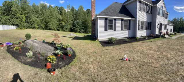 Panoramic view of the new foundation and boulder garden beds