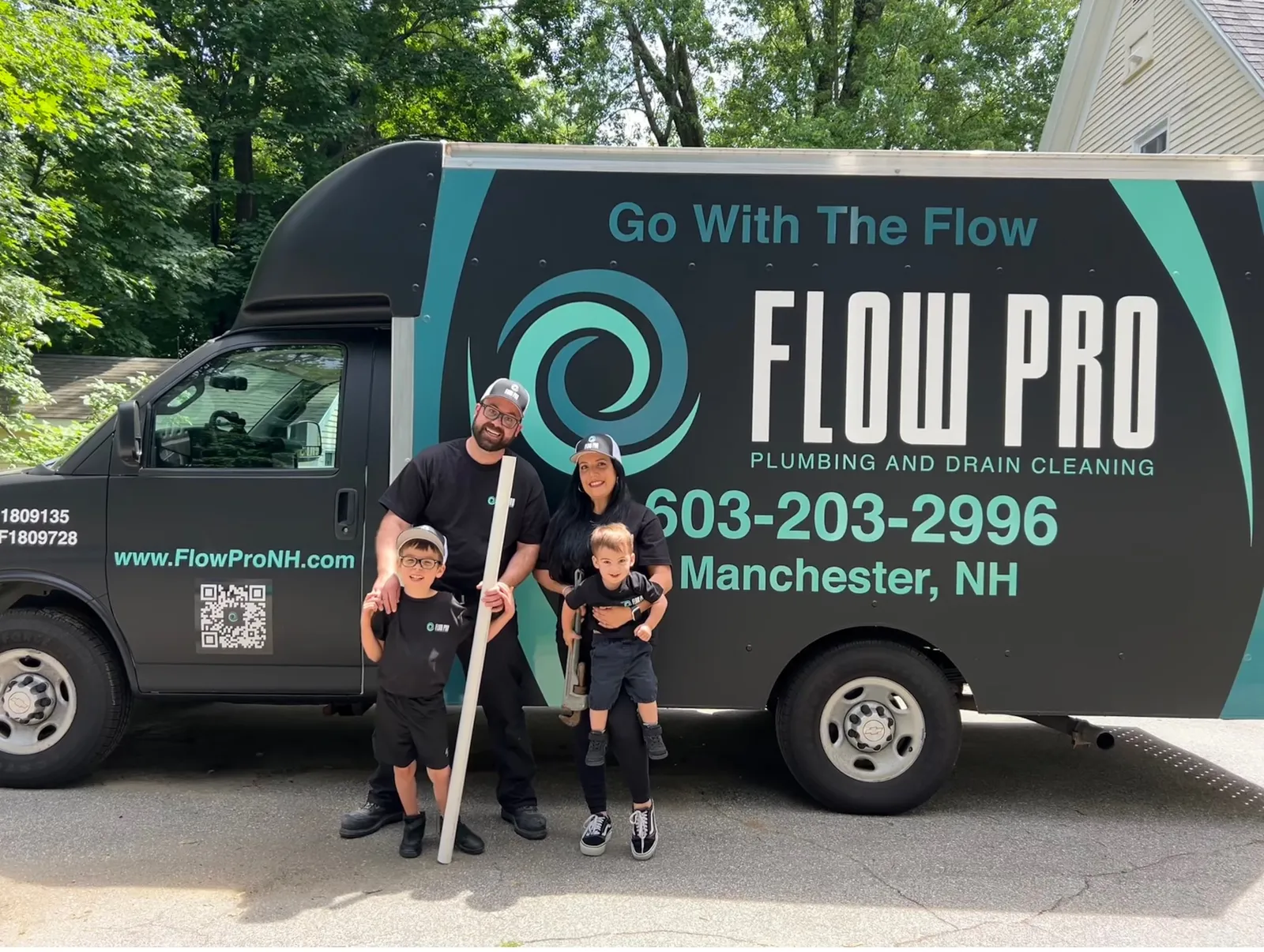 Flow Pro Plumbing and Drain Cleaning team standing in front of company service truck, trusted plumber Manchester NH providing professional plumbing and drain cleaning services.