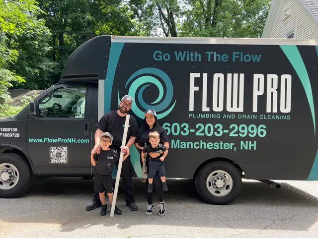 Flow Pro Plumbing and Drain Cleaning team standing in front of company service truck, trusted plumber Manchester NH providing professional plumbing and drain cleaning services.