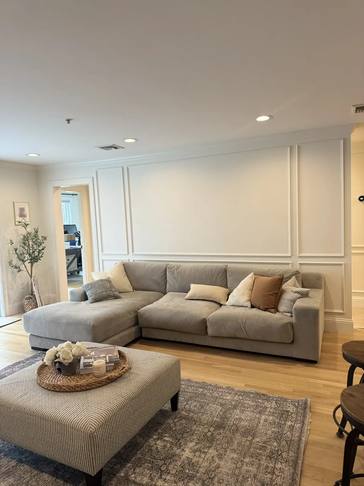 Living room wall in fitted panel millwork, running full height beside a doorway