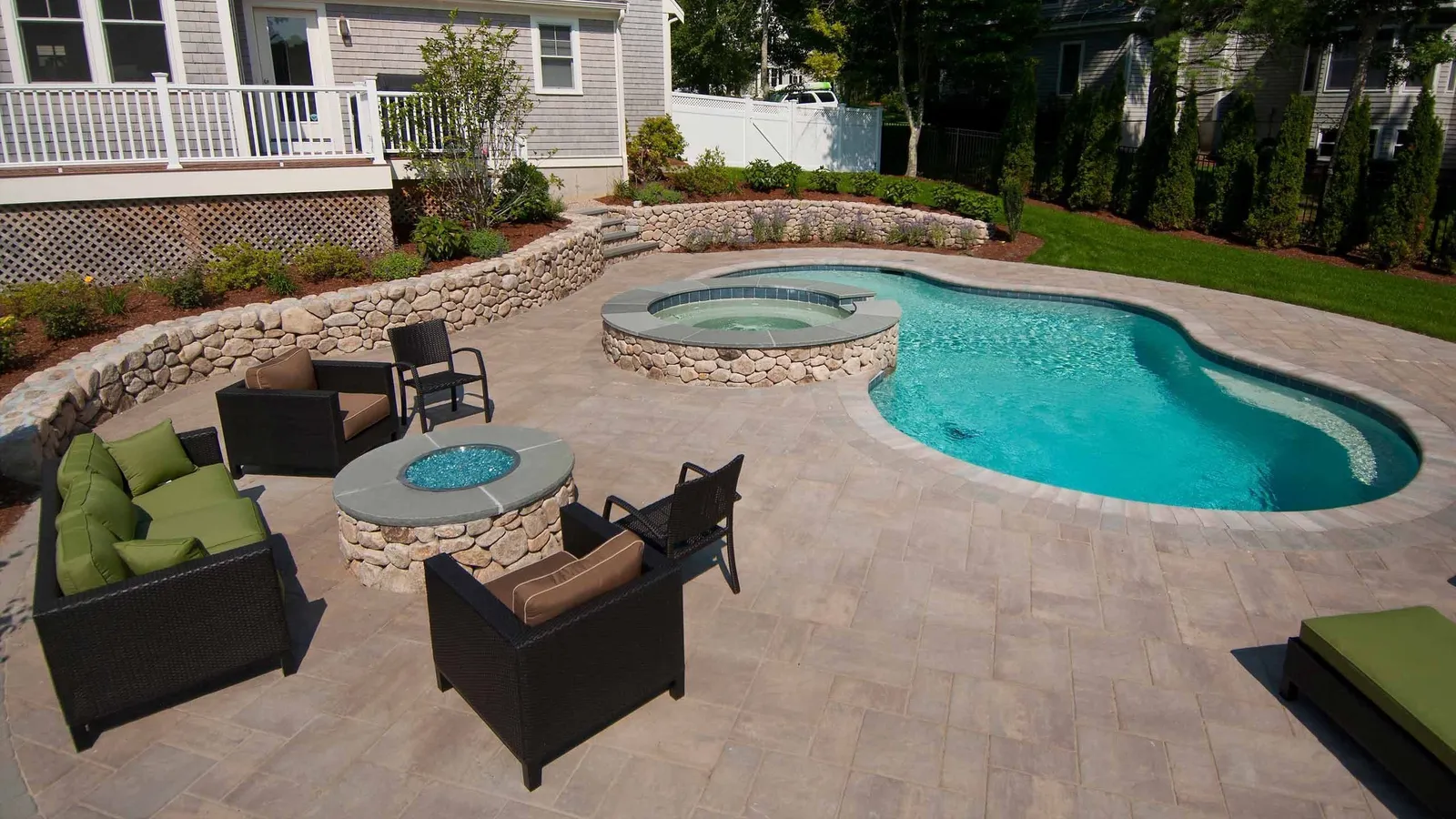 Cape Cod swimming pool with backyard firepit