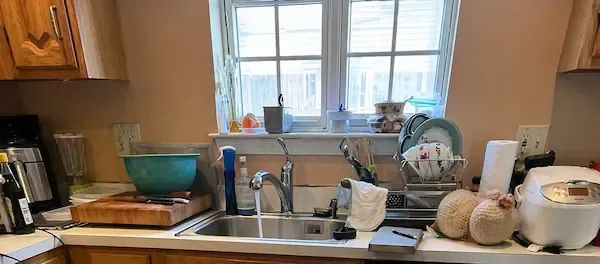 Kitchen sink with running water and faucet during plumbing inspection service in Norwalk CT
