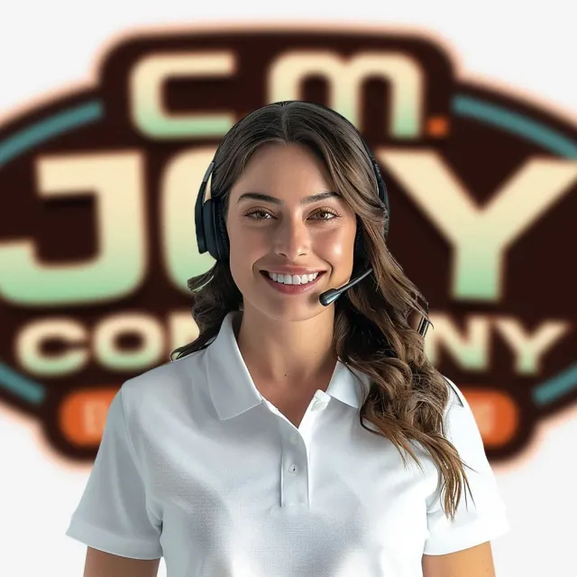 Customer service staff standing in front of C.M. Joy Company signage
