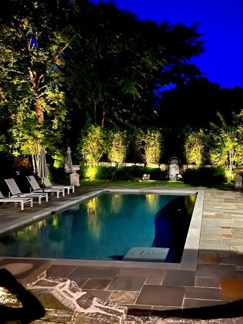Lights around an elegant outdoor swimming pool