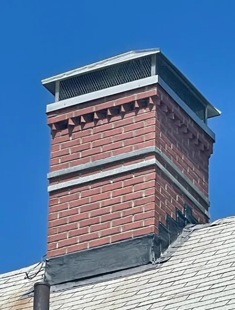 Full chimney rebuild with granite accents and hip and ridge cap