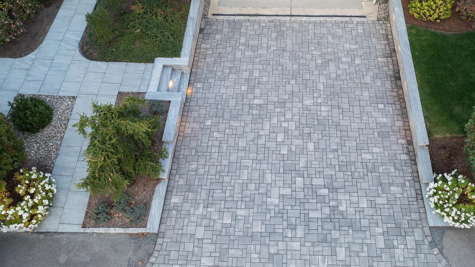 Paver driveway with retaining wall, lighted steps and walkway in bristol county Massachusetts