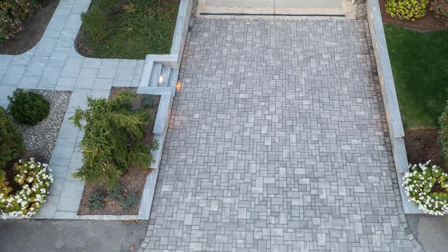 Paver driveway with retaining wall, lighted steps and walkway in bristol county Massachusetts