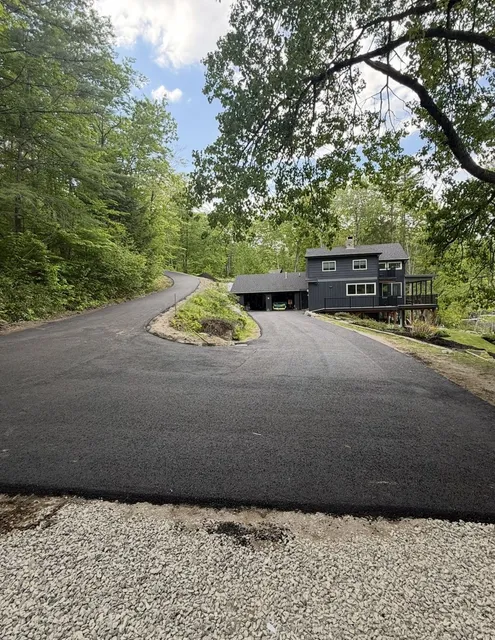Paved driveway in the woods
