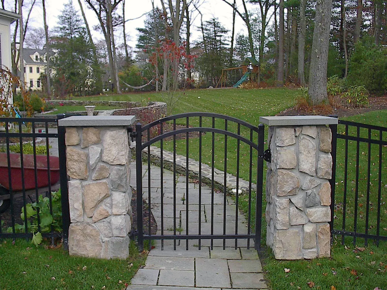 Ornamental iron gate set between stone pillars