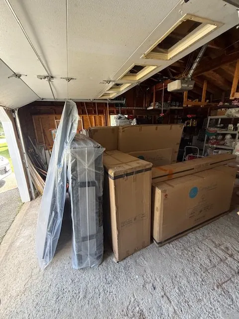 Flat-pack furniture delivered to a client's garage ahead of assembly