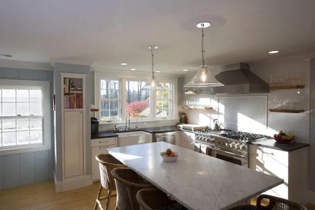 Modern kitchen remodel by Oxland Builders in New Hampshire featuring ample natural light and a clean design aesthetic