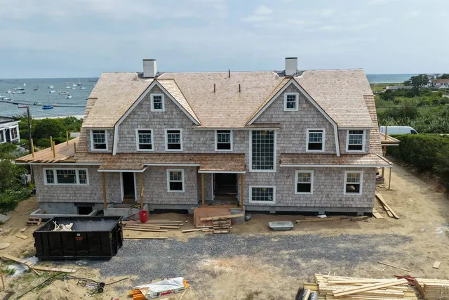 Red copper standing seam roof section between gables