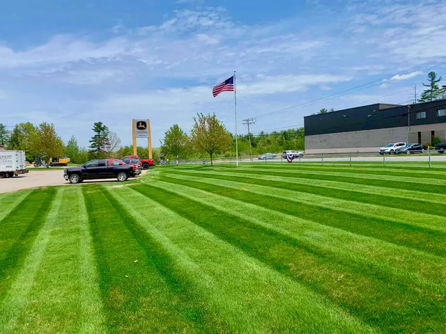 Perfectly striped green lawn outside a commercial property, professionally maintained by Perfect North Lawn Care in New Hampshire.