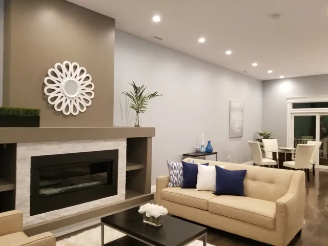 Living room with recessed ceiling lights and illuminated dining area