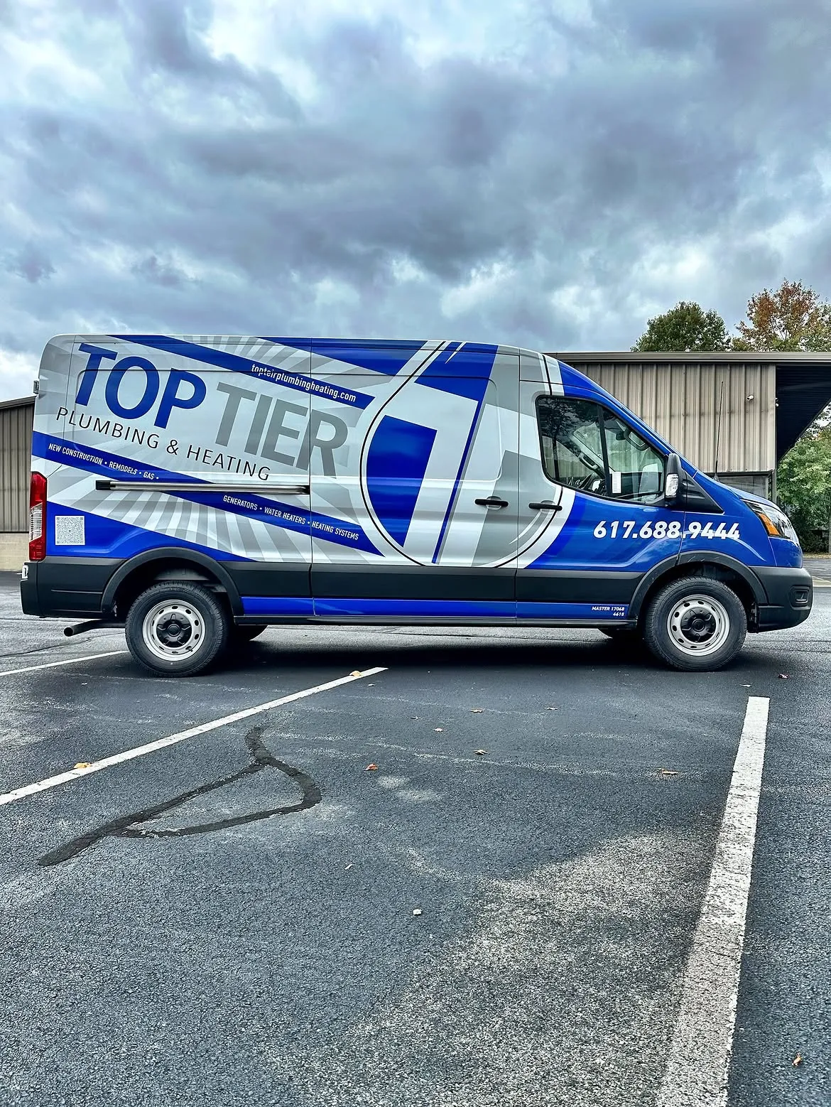 Top Tier Plumbing & Heating LLC service van — blue and white Ford Transit with company branding