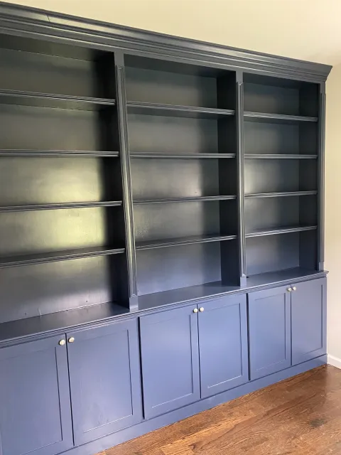 Floor-to-ceiling storage in an office—complete with custom sound barrier insulation behind the built-ins.