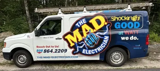 White electrician van with “The MAD Electrician” and “Shockingly good work” branding on the side.