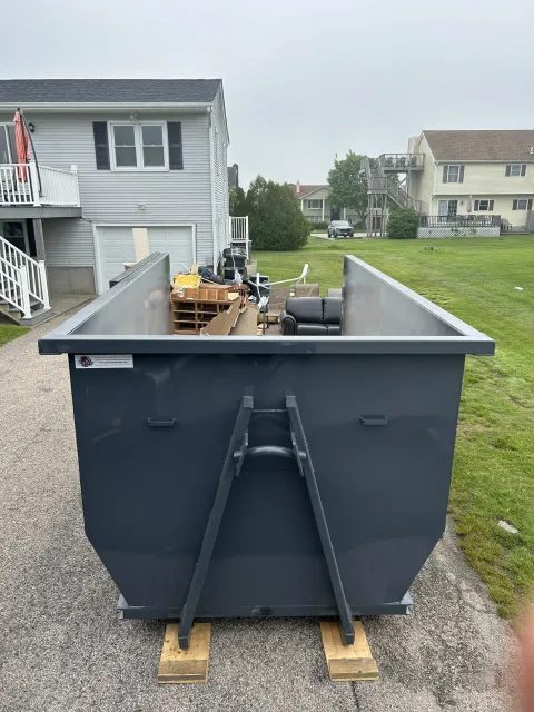 20 yard dumpster loaded with household furniture on a home cleanout job in Rhode Island