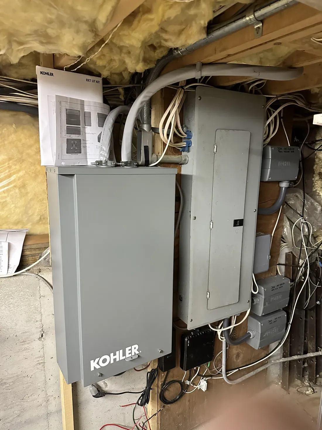 Automatic transfer switch installed beside an existing electrical panel