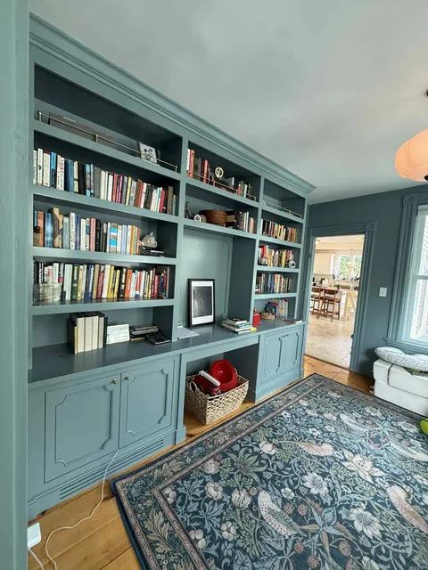 Custom built-in library bookcases with cabinet base in blue