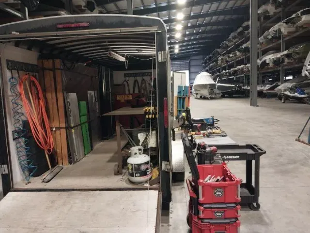Fully equipped mobile welding trailer interior with tools, gas, and cables for portable welding jobs by Warrior Welding