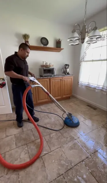 A PCRS technician deep-cleaning a tile floor