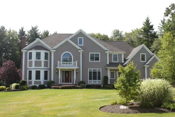 Grey custom colonial with balcony over the entry