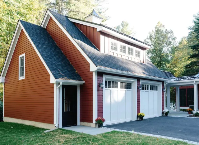 Red garage with white doors, black roof, and small cupola.