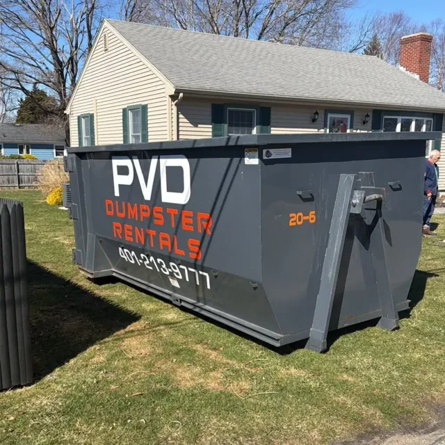20 yard dumpster placed on a yard for a yard waste cleanup in Rhode Island