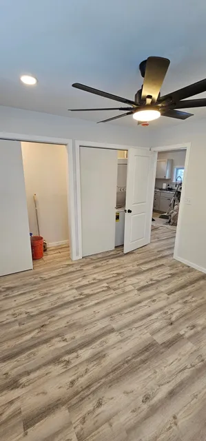 ADU bedroom with ceiling fan and closets