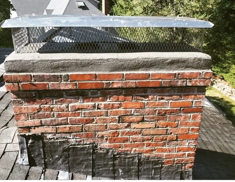 A brick chimney sitting on top of a roof