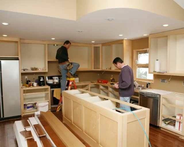 two cabinet installers in kitchen