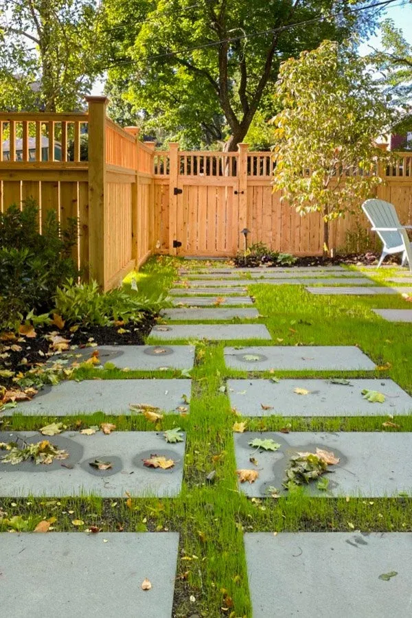 Custom wood fence and gate with bluestone steppers in lawn