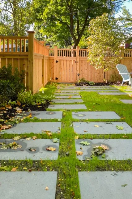 Custom wood fence and gate with bluestone steppers in lawn