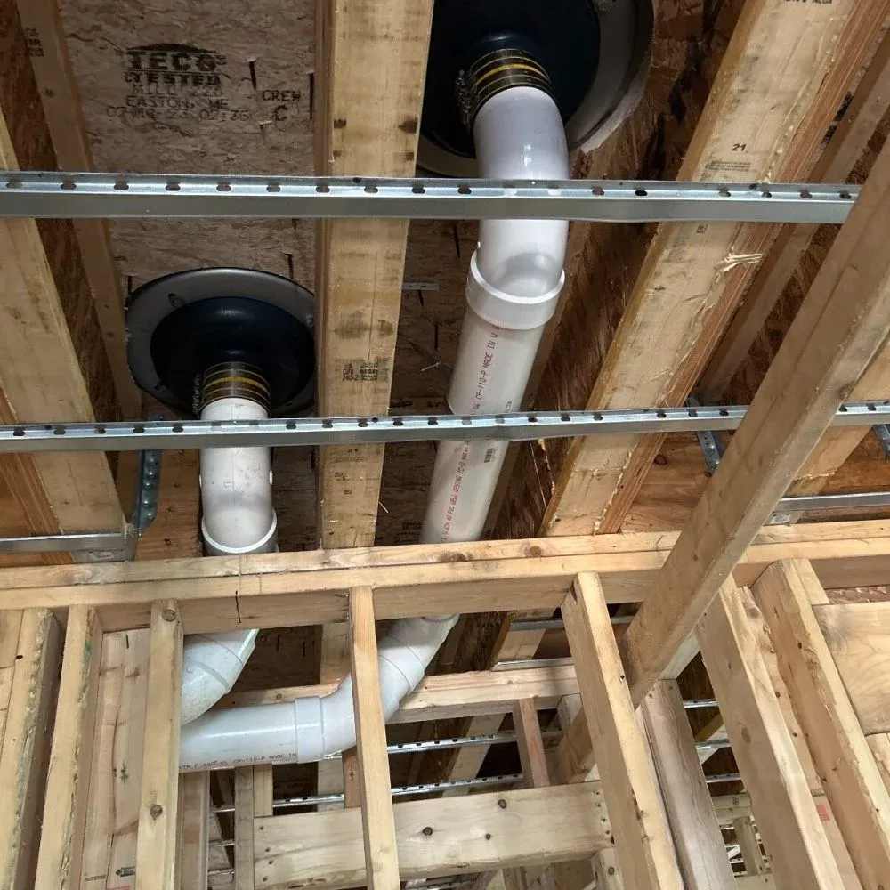 New construction site with visible plumbing infrastructure