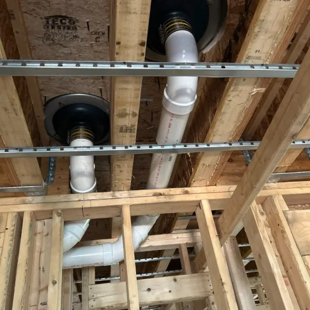 New construction site with visible plumbing infrastructure