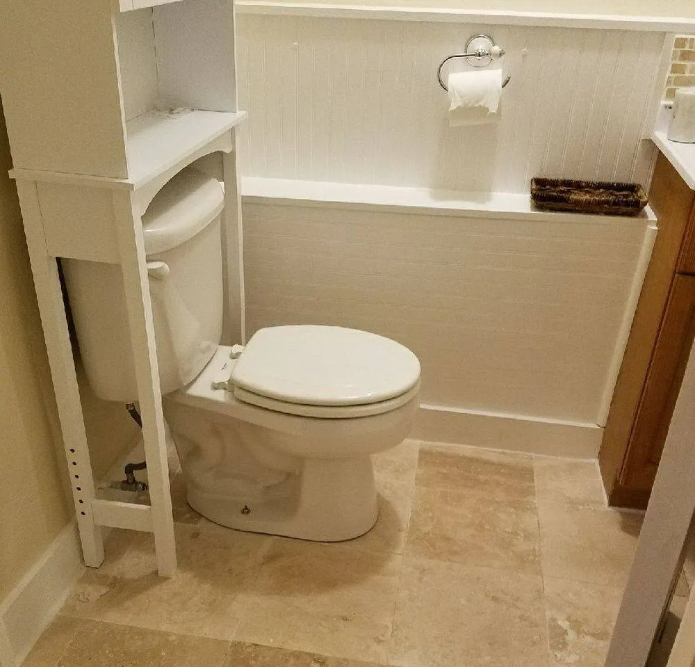 Bathroom remodel with beadboard and travertine floor