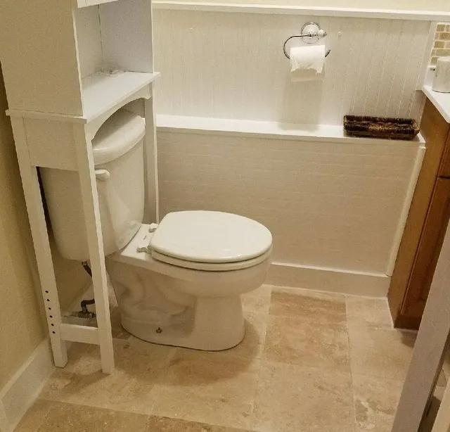 Bathroom remodel with beadboard and travertine floor