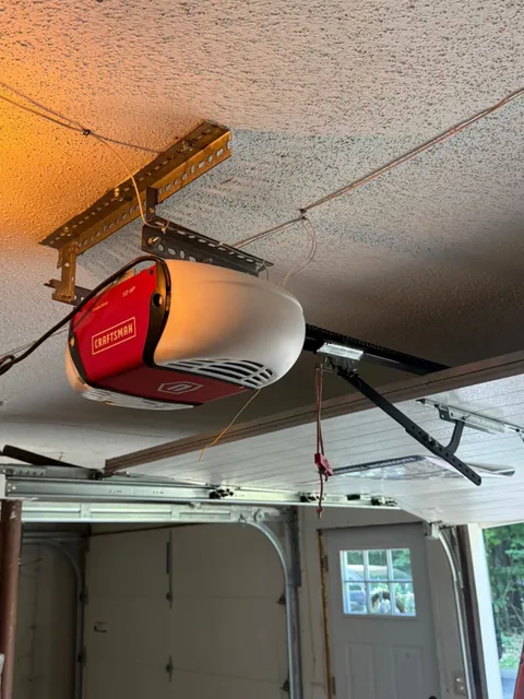 Old red Craftsman chain-drive garage door opener before replacement