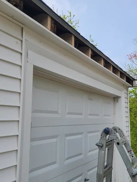 Fascia repair in progress on garage